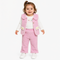 A toddler girl wearing a pink textured knit vest and matching pants over a white long-sleeve shirt, standing against a plain white background.