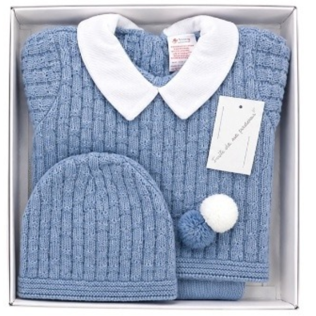Blue cable-knit baby outfit set neatly packaged in a white gift box, featuring a sweater with a white Peter Pan collar, pom-pom detail, and a matching knitted beanie hat.