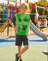 Child wearing a green Minecraft-themed shirt on a playground