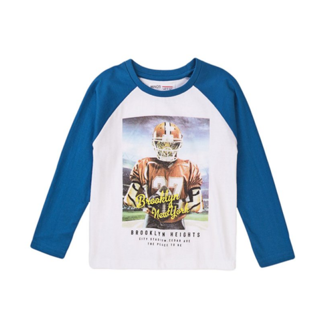 A kids' long-sleeve raglan shirt with blue sleeves and collar, and a white body featuring a large graphic of a football player with 'Brooklyn New York' text and 'Brooklyn Heights' below.