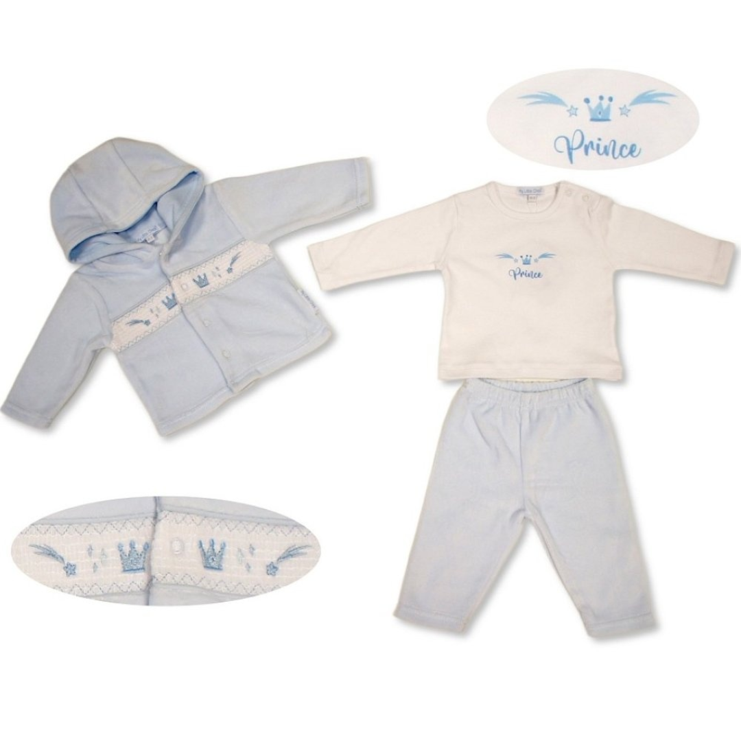 A baby boy's two-piece clothing set laid out on a white background, featuring a light blue hooded jacket with a decorative chest panel and matching light blue pants. The set also includes an off-white long-sleeve top with a blue 'Prince' design and a matching off-white embroidered bib.