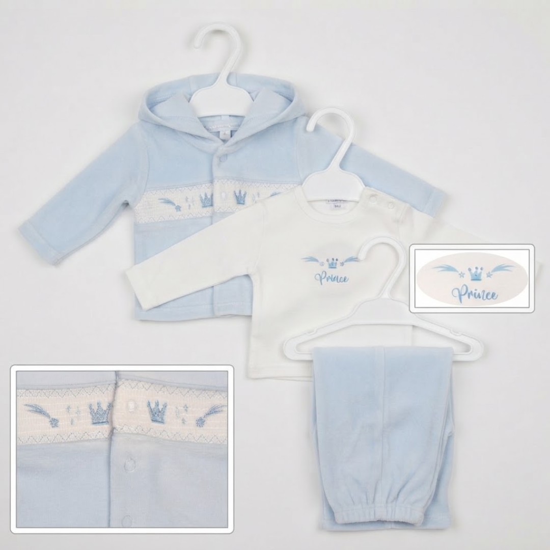 A baby clothing set displayed on white hangers against a light gray background, featuring a light blue hooded sweatshirt with a white embroidered chest panel, a white long-sleeve top with blue 'Prince' lettering, light blue pants, and inset detail views showing the chest embroidery and a close-up of the hood.