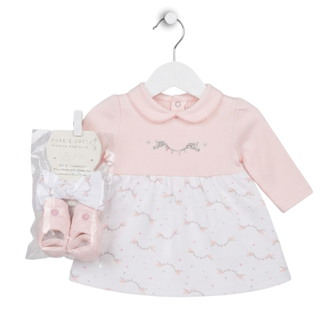 A baby girl's two-piece outfit set featuring a light pink and white long-sleeve dress with a printed unicorn pattern, shown with a matching pair of pink booties in a clear plastic bag. The dress is displayed on a white hanger against a solid white background.