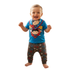 Happy toddler standing in a blue Superman outfit and matching bib.