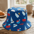 Blue bucket hat with colorful boat pattern on a wooden surface