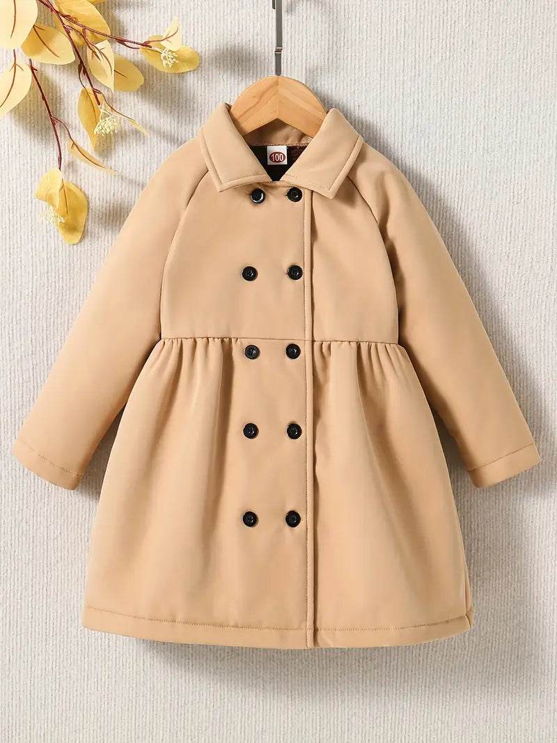 Beige coat with black buttons on a textured beige background