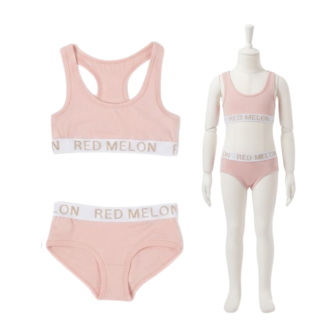 A three-piece girls' underwear set in light pink, featuring a racerback bralette, high-waisted briefs, and a matching tankini-style bottom, shown both flat and displayed on a child mannequin. The elastic bands are white with the brand name 'RED MELON' printed in gold.