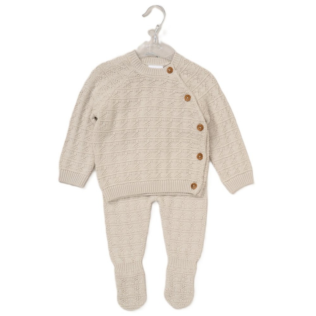 Knitted baby outfit with buttons on a hanger against a white background