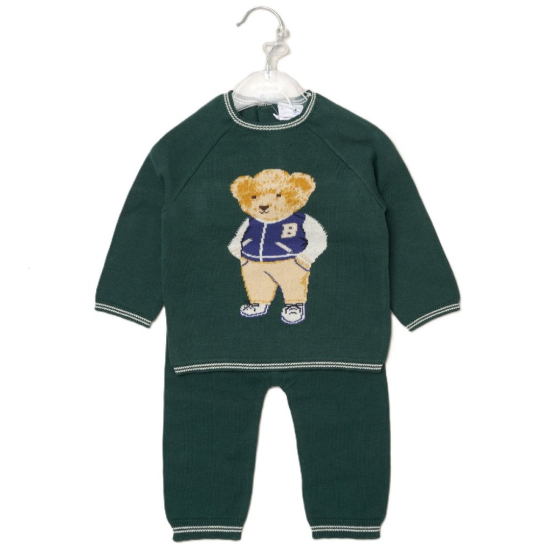 A dark green baby one-piece jumpsuit with a knitted teddy bear graphic on the chest, hanging on a clear plastic hanger against a white background.