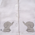 Close-up of a white knit cardigan with white buttons and gray embroidered elephant motifs on both sides near the hem.
