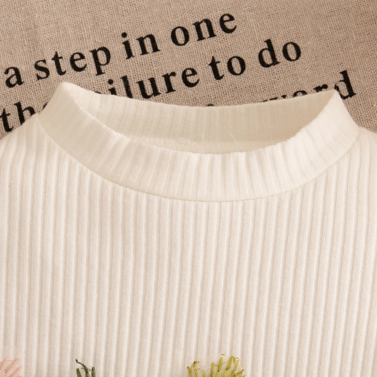 Close-up of a textured white fabric with text in the background