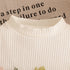 Close-up of a textured white fabric with text in the background
