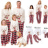 Family matching Christmas pajamas with reindeer design and plaid pants.