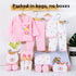 Baby clothing set with pink outfit, white pants, and accessories on hangers against a white background.