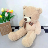 Beige teddy bear with a heart-shaped 'Love' tag next to tulips on a checkered floor.