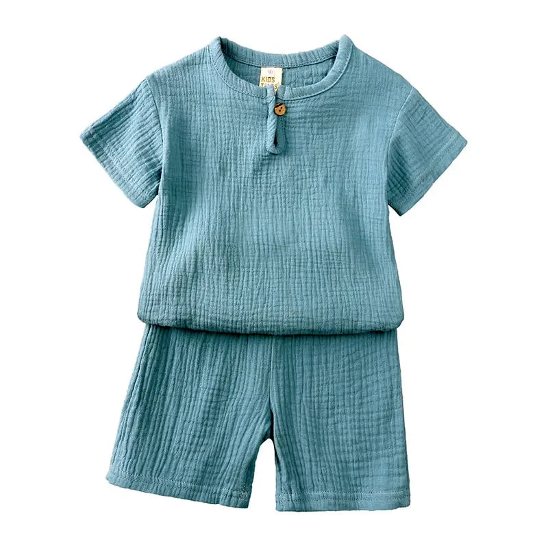 Blue baby outfit with shirt and shorts on a white background