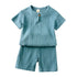 Blue baby outfit with shirt and shorts on a white background