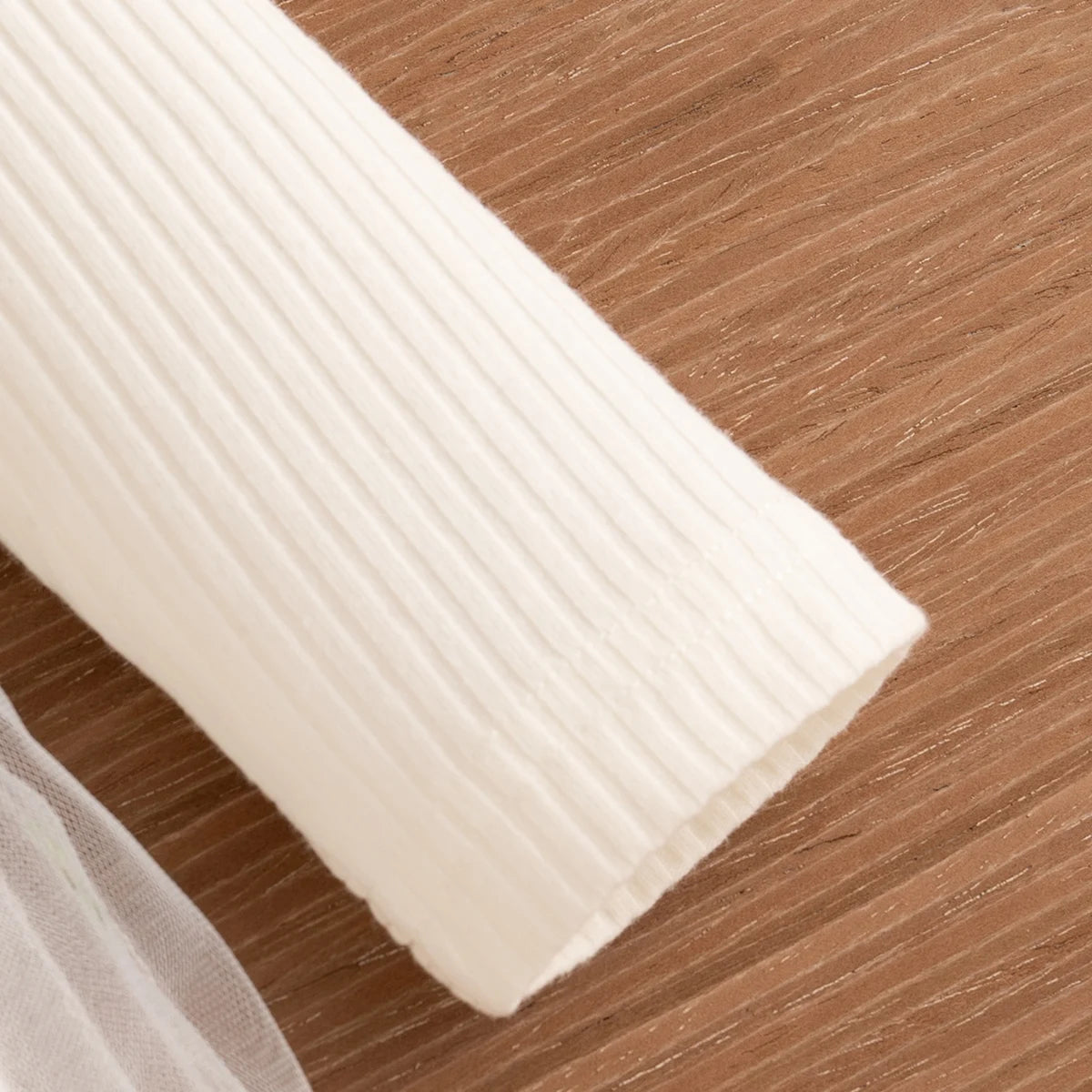 Roll of white paper on a wooden surface