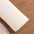 Roll of white paper on a wooden surface