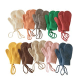 Set of colorful knitted mittens arranged in a grid on a white background