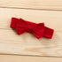 Red bow tie on a wooden surface