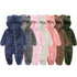 Row of colorful baby onesies with bear ears on a white background