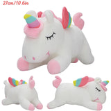 Two plush unicorn toys with rainbow horns on a white background