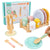Children's toy dinnerware set with a hand holding a spoon, displayed on a wooden surface.