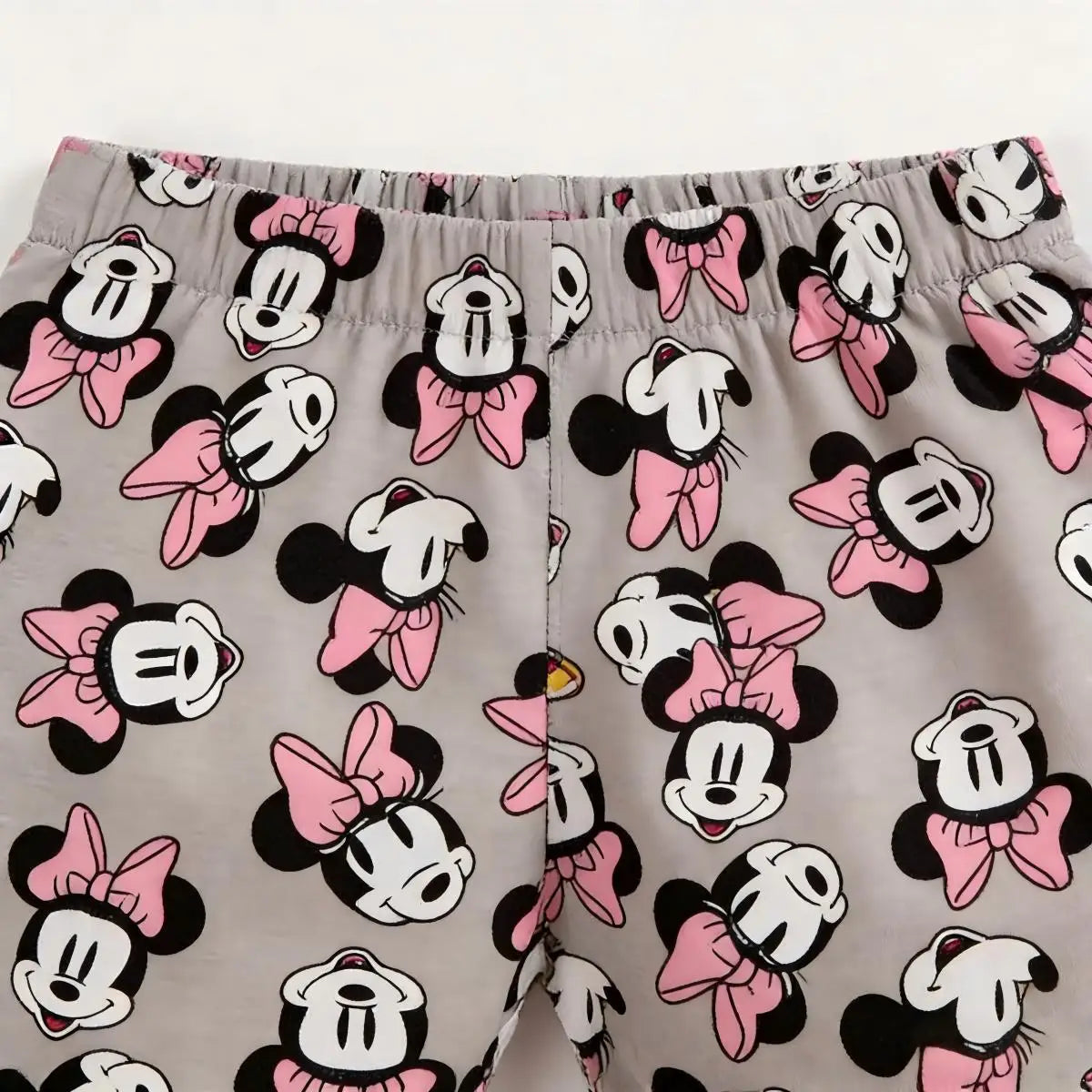 Pajama shorts with Minnie Mouse pattern on a gray background
