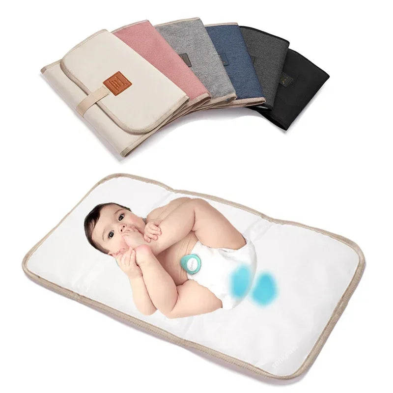 Baby changing pad with a baby's picture on it, surrounded by various color options of the pad.
