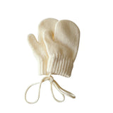 Pair of cream-colored baby mittens on a white background