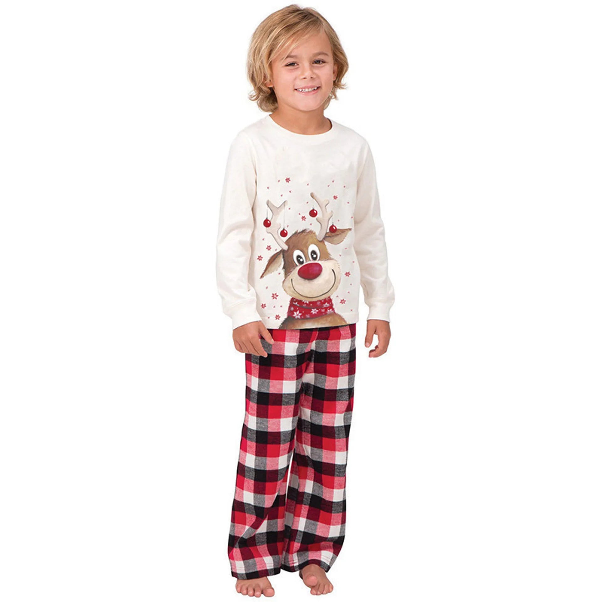 Child wearing a Christmas-themed pajama set with a reindeer design on a white background