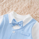 Light blue vest with a bow tie on a white shirt against a beige textured background