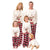 Family wearing matching Christmas pajamas with reindeer designs on a white background