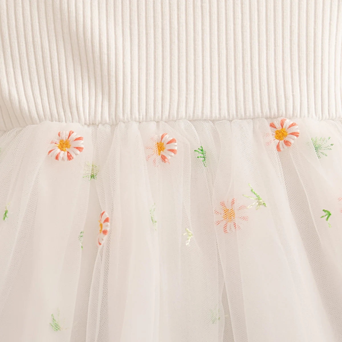 White fabric with embroidered flowers on a white background