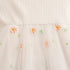 White fabric with embroidered flowers on a white background