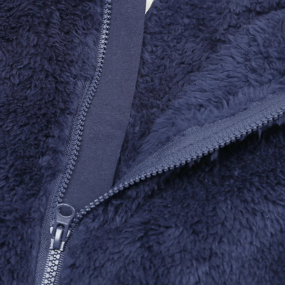 Close-up of a navy blue fleece jacket zipper