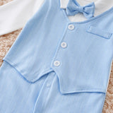 Light blue baby outfit with buttons and a bow tie on a textured surface