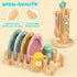 Wooden toy kitchen set with plates, cups, and a stand on a beige background
