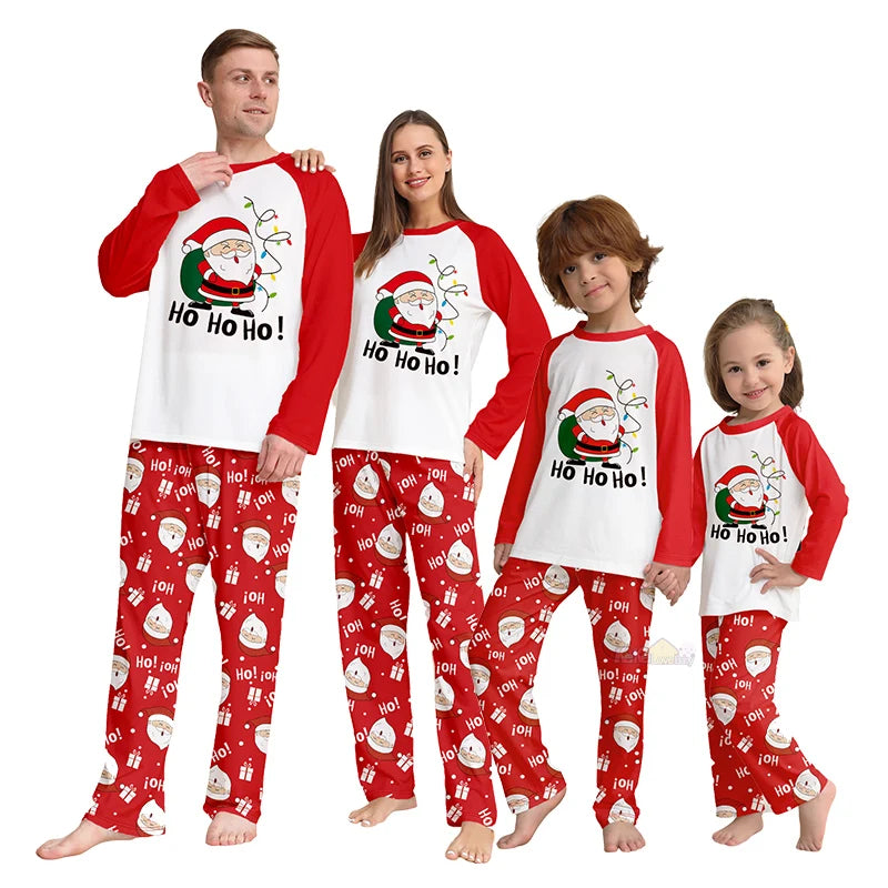 Family wearing matching Christmas pajamas with Santa Claus design.
