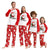Family wearing matching Christmas pajamas with Santa Claus design.