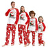 Family wearing matching Christmas pajamas with Santa Claus design.