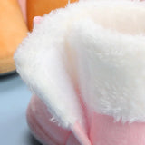 Close-up of a fluffy white object with pink interior, possibly a toy or cushion.
