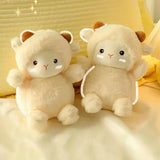 Two cute plush toys resembling cats on a soft surface with a yellow background