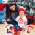 Woman and baby playing with toys in a festive setting
