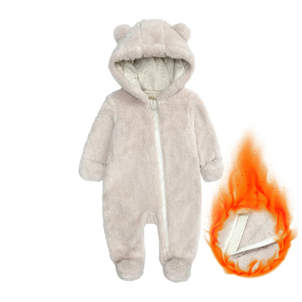 Baby onesie with bear ears and hood on a white background, with a flame graphic indicating flammability.