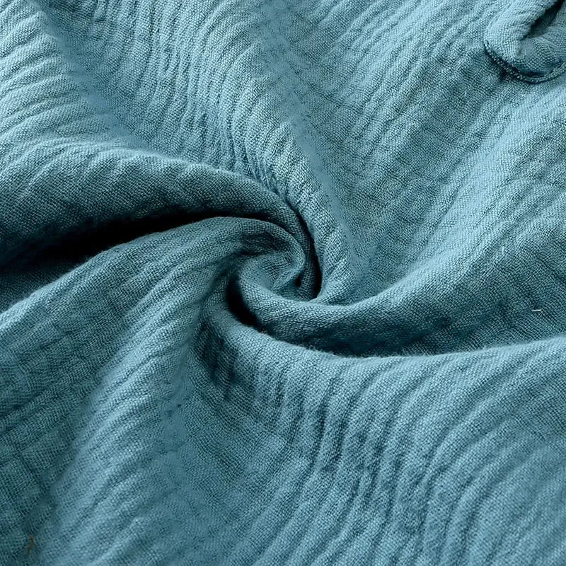 Close-up of textured teal fabric with a swirl pattern