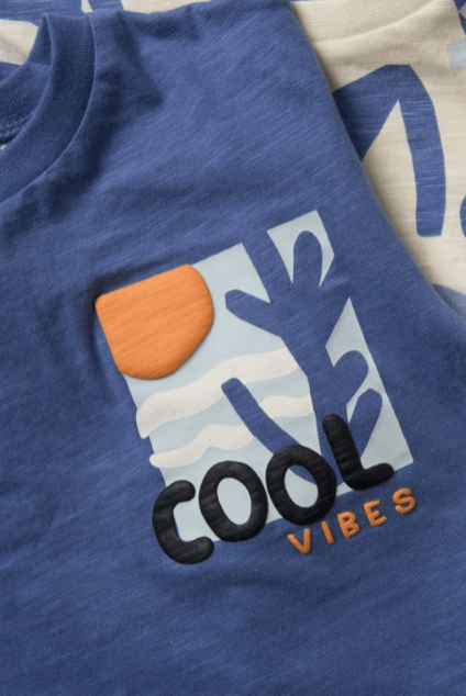 Close-up of a blue t-shirt featuring a textured, raised 