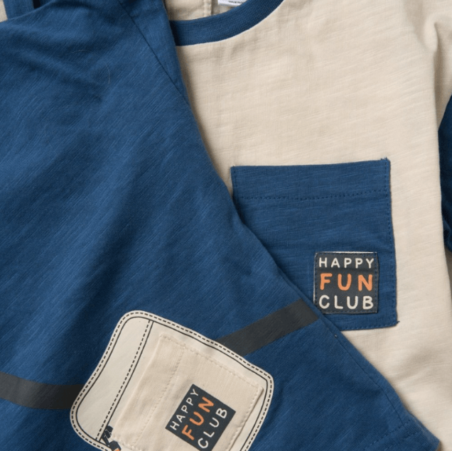 Two shirts with 'Happy Fun Club' patches on a blue and beige background