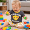Child playing with toys wearing a 'Lion King' shirt in a living room setting